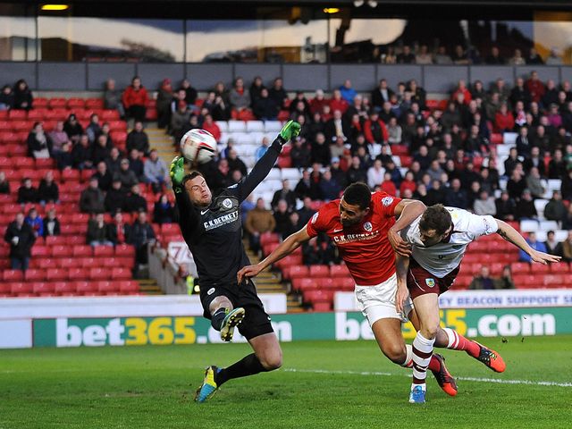 Burnley's Ashley Barnes heads on goal