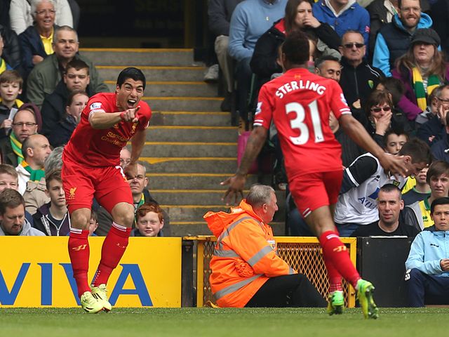 Luis Suarez celebrates with Raheem Sterling