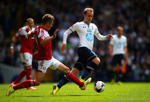 Alex Kacaniklic of Fulham attempts to tackle Christian Eriksen of Tottenham