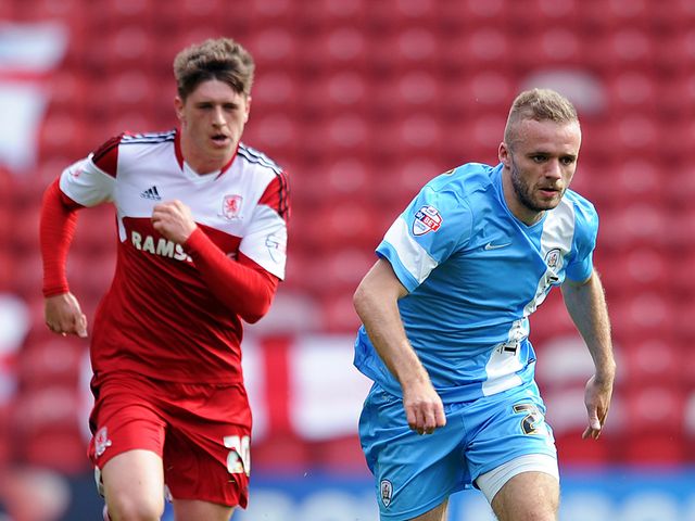 Adam Reach of Middlesbrough chases Ryan McLaughlin of Barnsley