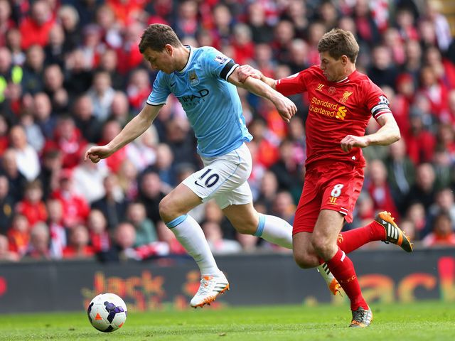 Edin Dzeko is put under pressure by Steven Gerrard
