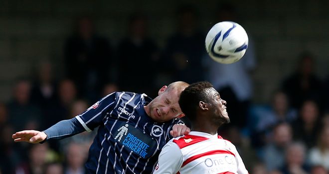 Millwall's Alan Dunne heads away from Doncaster's Theo Robinson