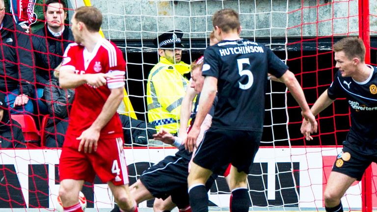 Craig Reid scrambles in the late winner for Motherwell at Aberdeen