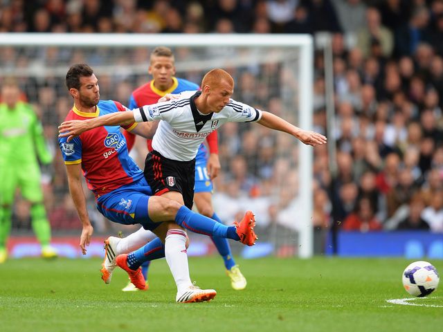 Steve Sidwell is tackled by Joe Ledley