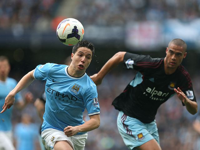 Samir Nasri and Winston Reid chase the ball