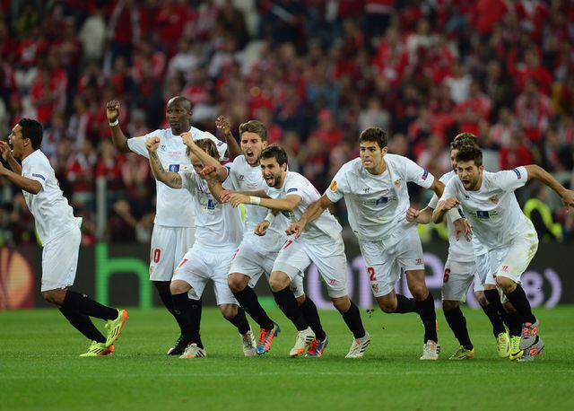 Sevilla players celebrate after Kevin Gameiro scores the winning penalty