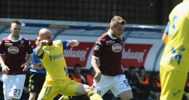 Ciro Immobile competes the ball with Roberto Guana