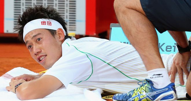 Kei Nishikori has treatment during his Madrid final defeat to Rafael Nadal