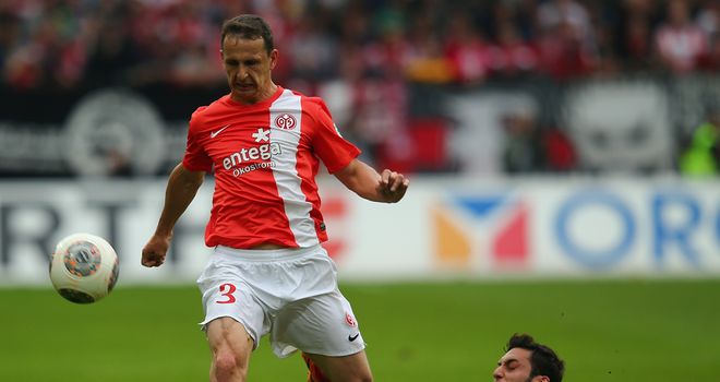 Zdenek Pospech is challenged by Hakan Calhanoglu