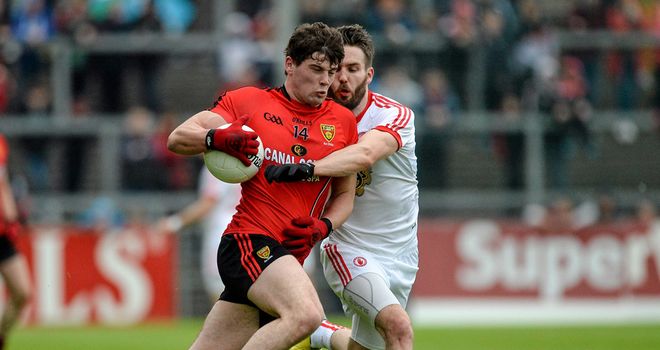 Ciaran McGinley, pictured tackling Niall Madine, netted in either half for Tyrone in Newry