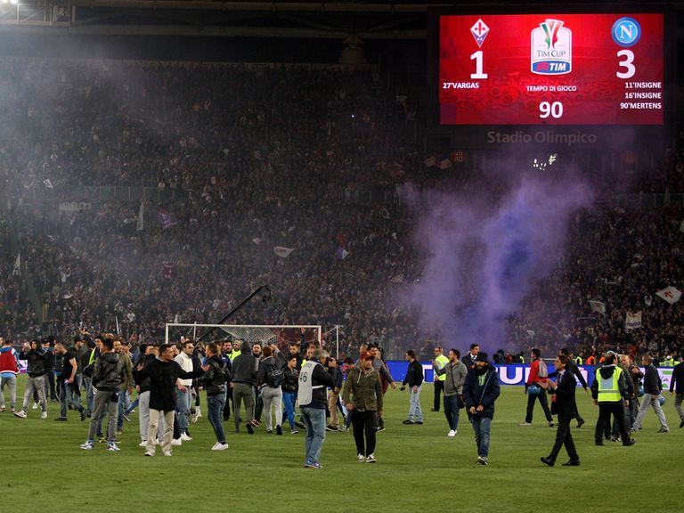 Napoli fans enter the field of play after the Coppa Italia final