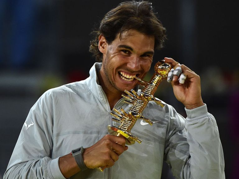 Spanish player Rafael Nadal poses with the trophy