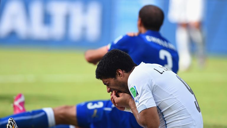 Luis Suarez: Holds his mouth after incident
