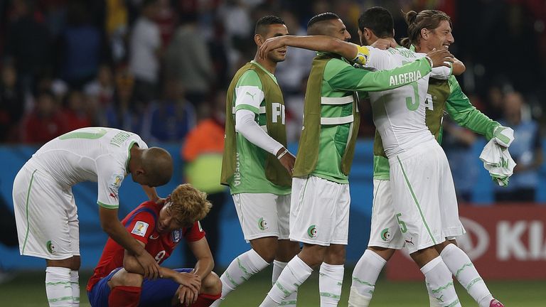 Sofiane Feghouli (l): Speaks with South Korea's midfielder Son Heung-Min as Algerian players celebrate