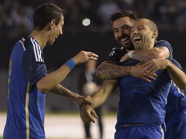Javier Mascherano celebrates with Ezequiel Lavezzi and Angel Di Maria