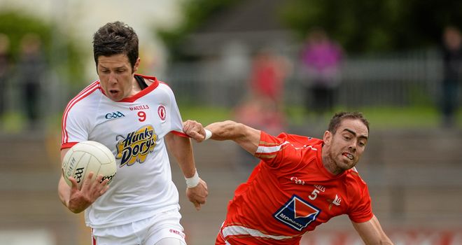 Tyrone captain Sean Cavanagh is challenged by John O'Brien
