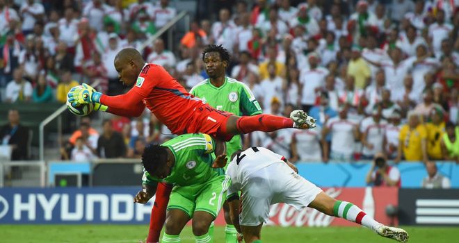 Vincent Enyeama of Nigeria makes a save over Joseph Yobo and Ashkan Dejagah of Iran