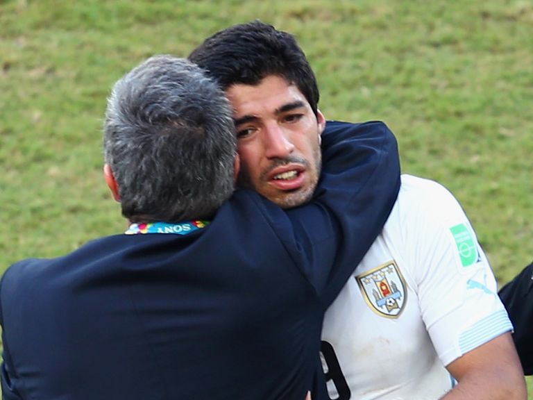 Uruguay manager Oscar Tabarez hugs Luis Suarez