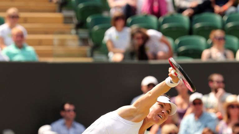 Romania's Simona Halep serves to Kazakhstan's Zarina Diyas during their women's singles fourth round match
