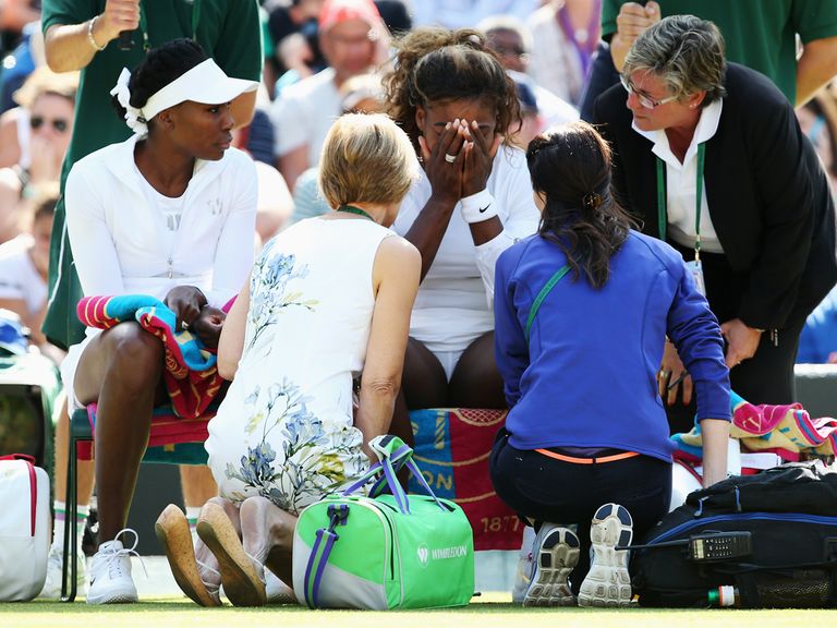 Serena Williams is attended to by medical staff at Wimbledon