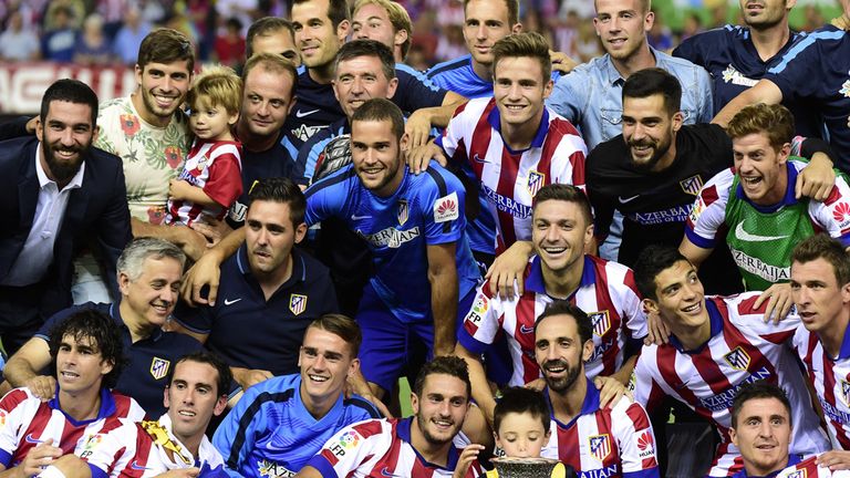 Atletico players show off the trophy