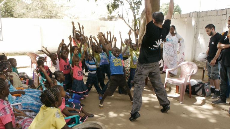 Amir and the kids stretch - or celebrate!