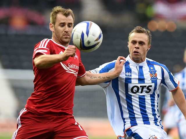 Aberdeen's Niall McGinn goes up against Chris Chantler