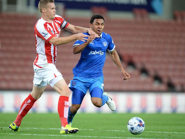 Portsmouth's Andy Barcham battles for the ball with Stoke City's Ryan Shawcross