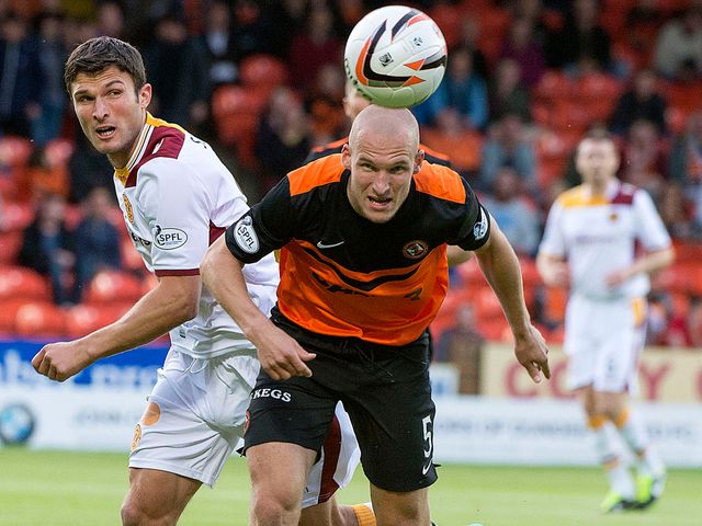 Motherwell's John Sutton chases Jaroslaw Fojut of Dundee United