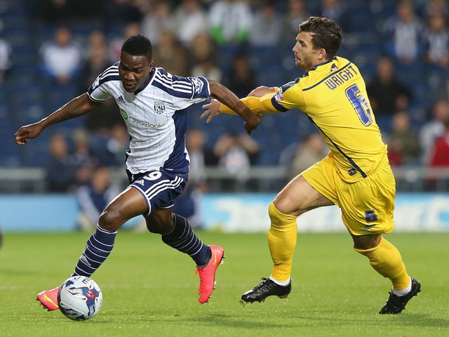 Brown Ideye of West Brom moves away from Jake Wright