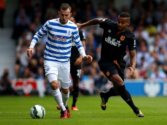 Tom Huddlestone of Hull City marshalls Jordan Mutch of QPR