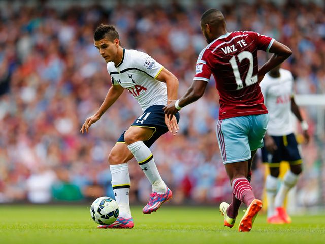 Erik Lamela of Tottenham holds off Ricardo Vaz Te