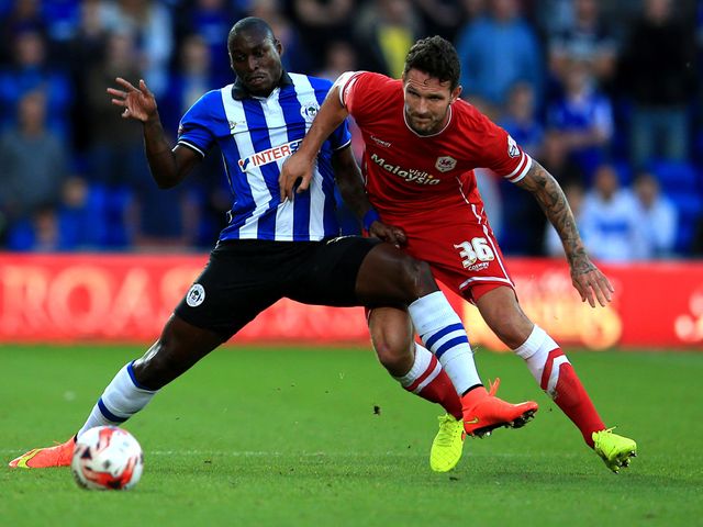 Wigan Atheltic's Marc-Antoine Fortune tussles for the ball with Cardiff City's Sean Morrison