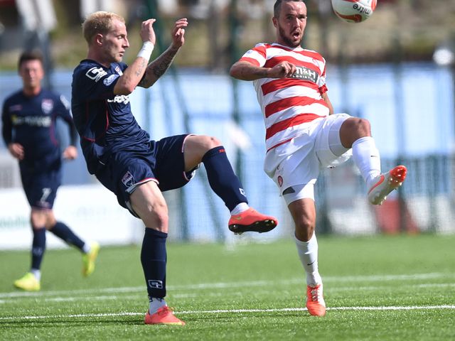 Ross County's Uros Celcer (left) challenges Dougie Imrie