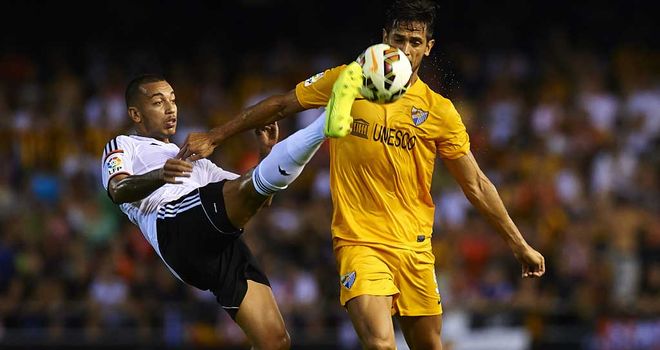 Ruben Vezo of Valencia competes for the ball with Roque Santa Cruz