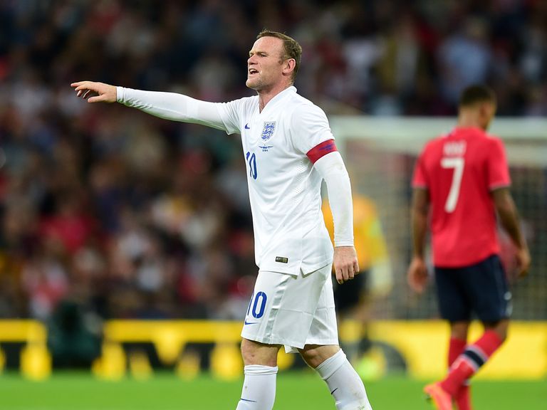 Wayne Rooney gestures to team-mates at Wembley