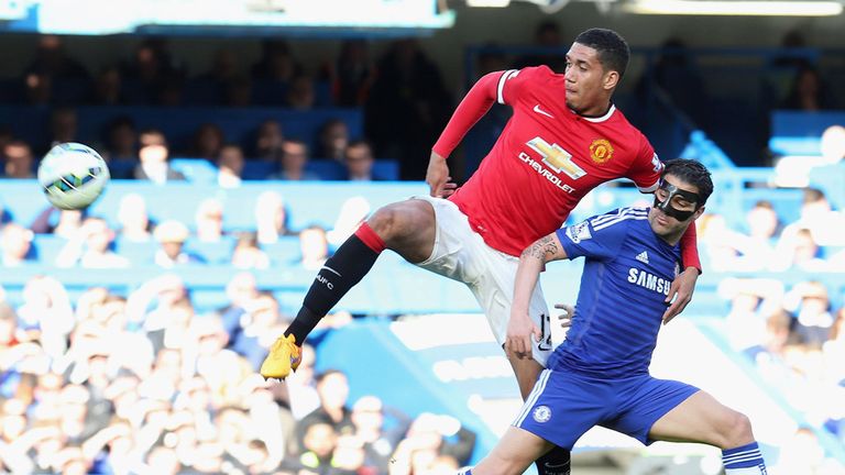 Cesc Fabregas tangles with Manchester United's Chris Smalling