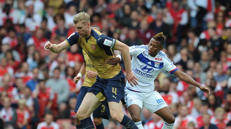 Njie pressurises Arsenal's Per Mertesacker of Arsenal during the recent Emirates Cup