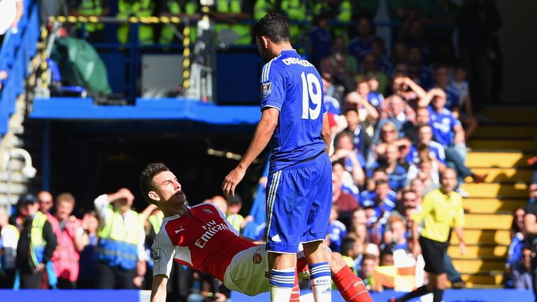 Laurent Koscielny falls to the ground following a chest pump by Diego Costa