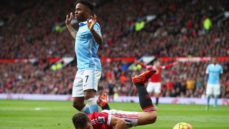 Ander Herrera falls under Raheem Sterling's challenge in Manchester derby at Old Trafford