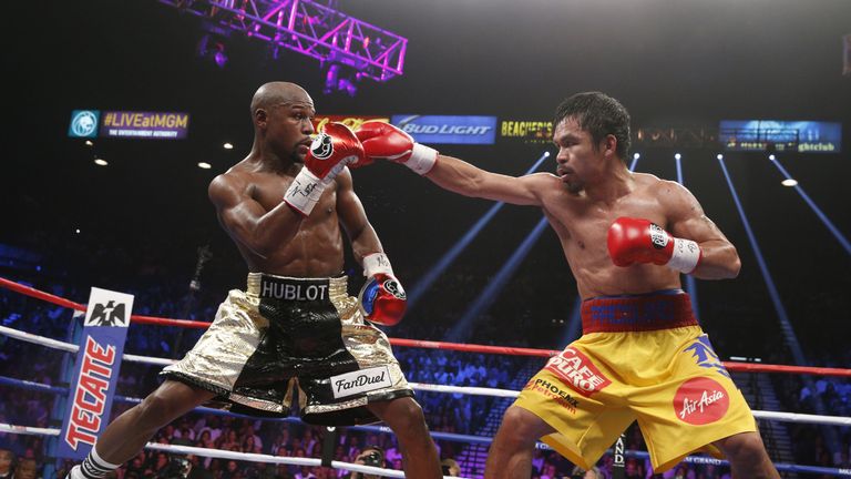 Manny Pacquiao (right) says he is in talks over a rematch with Floyd Mayweather