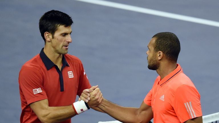 Djokovic shakes hands with Jo-Wilfried Tsonga (right) at the end of the match