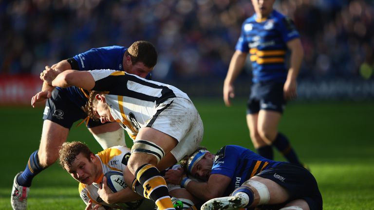 Joe Launchbury is tackled by Jamie Heaslip
