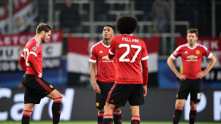 Dejected Manchester United players look on after conceding a third goal at Wolfsburg