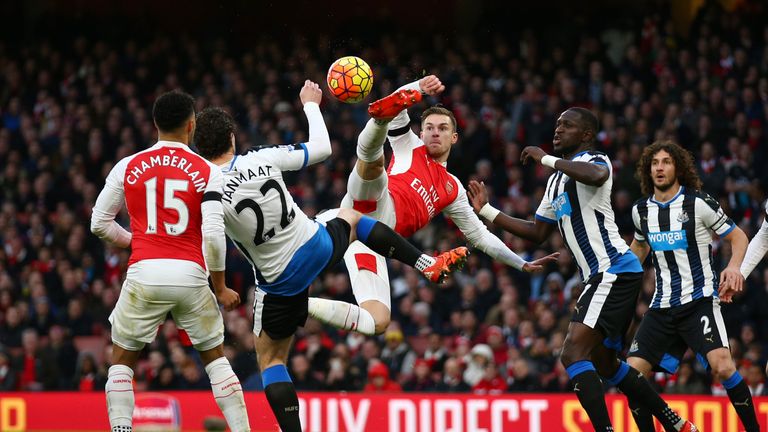 Aaron Ramsey and Daryl Janmaat compete for the ball