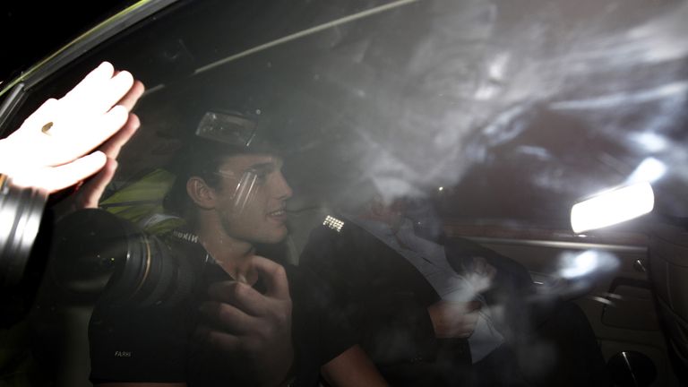 Photographers and fans swarmed Carroll's car as he arrived at Liverpool's Melwood training ground
