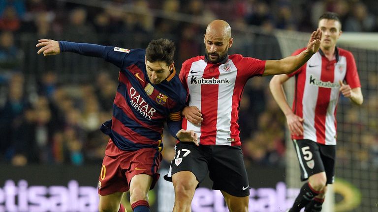 Lionel Messi (left) is challenged by Mikel Rico at the Nou Camp