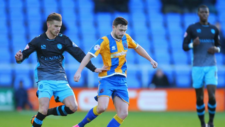 Michael Turner of Sheffield Wednesday and Andrew Mangan of Shrewsbury Town compete for the ball