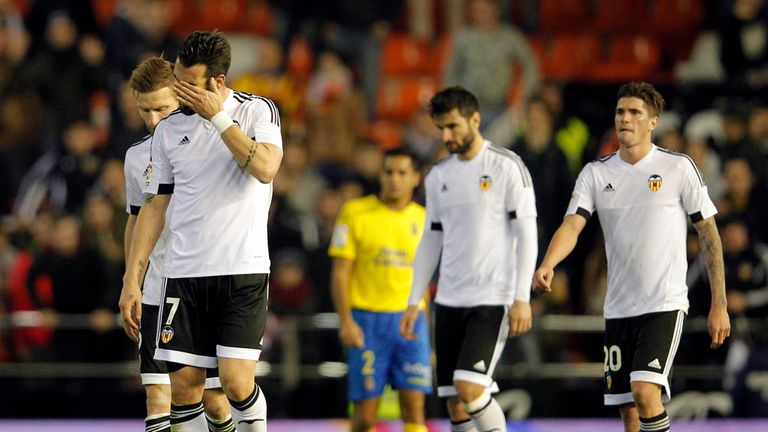 Valencia's players leave the field following the draw