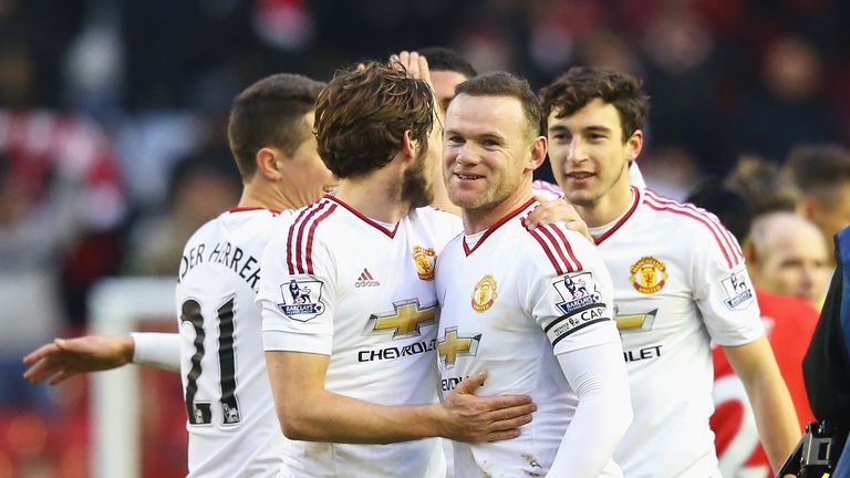 Wayne Rooney celebrates victory at Anfield with his Manchester United team-mates